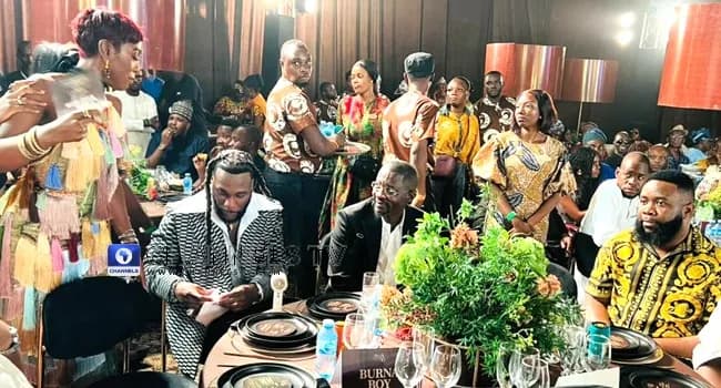 Burna Boy Honours Grandfather Benson Idonije at 90th Birthday